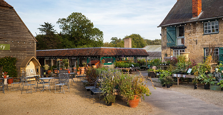 courtyard at Waterperry with displays of plants for sale